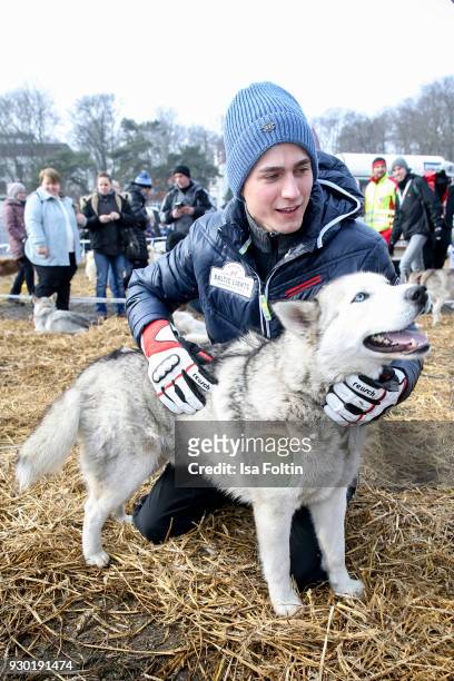 German actor Timothy Boldt plays with a sled dog during the 'Baltic Lights' charity event on March 10, 2018 in Heringsdorf, Germany. The annual event...
