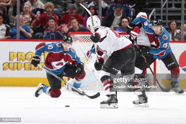 Niklas Hjalmarsson of the Arizona Coyotes takes a shot against Sven Andrighetto, Duncan Siemens and goaltender Semyon Varlamov of the Colorado...