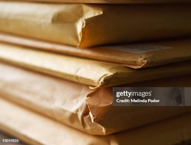 stack of manila envelopes or packages - brown envelope stock pictures, royalty-free photos & images