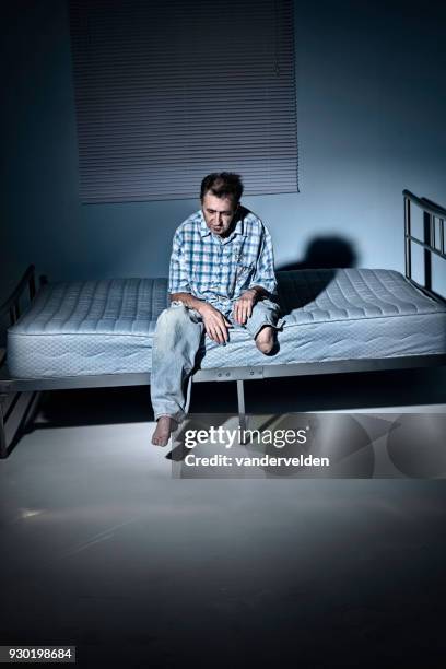 depressed, one-legged man in his lonely room - vandervelden stock pictures, royalty-free photos & images