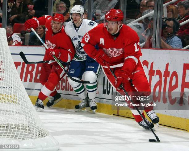 Pavel Datsyuk of the Detroit Red Wings controls the puck behind the net during a NHL game against the Vancouver Canucks at Joe Louis Arena on...