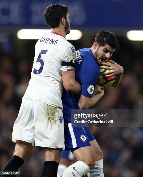 James Tomkins of Crystal Palace tries to wrestle the ball from Alvaro Morata of Chelsea during the Premier League match between Chelsea and Crystal...