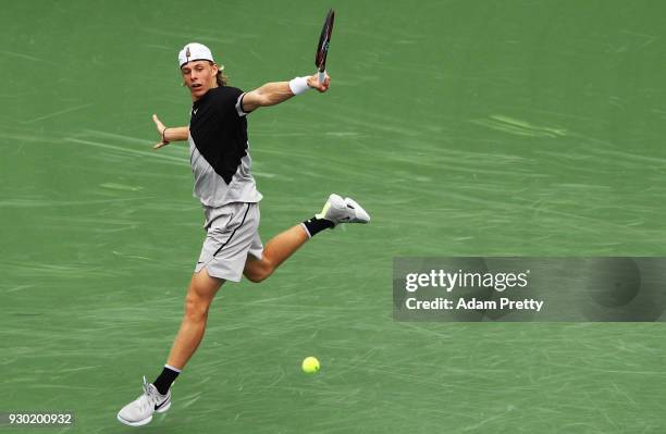 Denis Shapovalov of Canada hits a backhand during his match against Pablo Cuevas of Uruguay during the BNP Paribas Open at the Indian Wells Tennis...