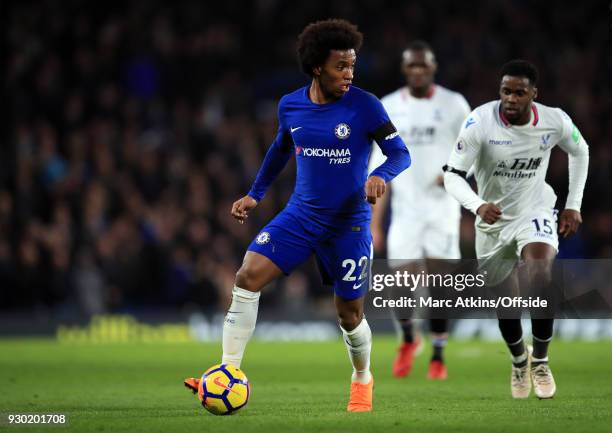 Willian of Chelsea in action with Jeffrey Schlupp of Crystal Palace during the Premier League match between Chelsea and Crystal Palace at Stamford...