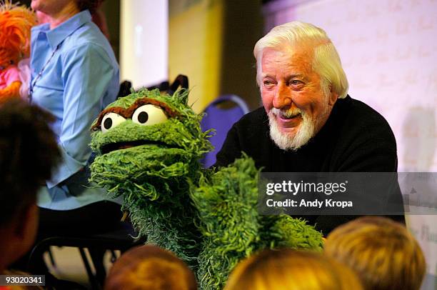Caroll Spinney, the puppeteer who brings to life characters such as Oscar the Grouch and Big Bird, entertains children at a promotion for "Sesame...