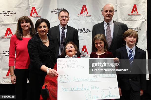 The Jackson family's youngest daughter Hope Jackson presents a check to President and CEO of ALSA Dorine Gordon at the 15th Annual Lou Gehrig Sports...