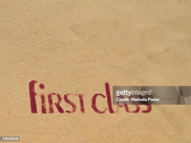 "first class" stamped on an envelope or package - brown envelope stock pictures, royalty-free photos & images