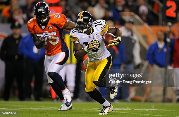 Santonio Holmes of the Pittsburgh Steelers makes a reception as DJ Williams of the Denver Broncos defends during NFL action at Invesco Field at Mile...