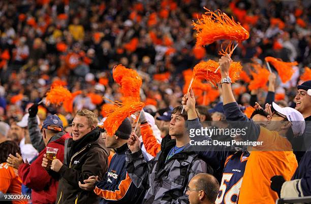 Fans support the Denver Broncos against the Pittsburgh Steelers defense on during NFL action at Invesco Field at Mile High on November 9, 2009 in...