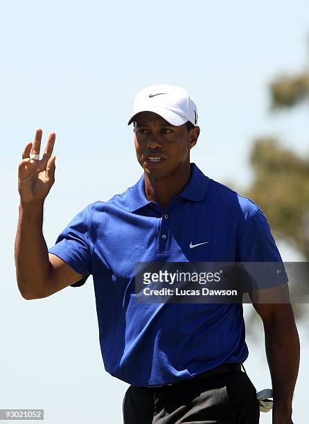 Tiger Woods of the USA acknowledges the crowd on the 7th hole during round two of the 2009 Australian Masters at Kingston Heath Golf Club on November...