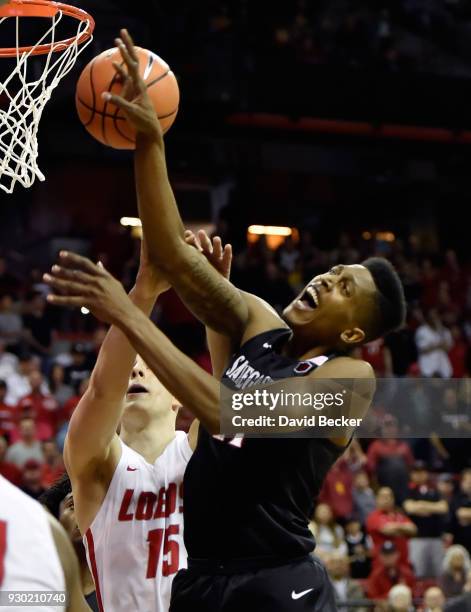 Malik Pope of the San Diego State Aztecs is fouled as he shoots against Vladimir Pinchuk of the New Mexico Lobos during the championship game of the...