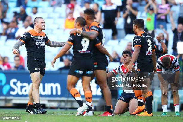 Russell Packer of the Tigers and his team mates celebrate victory during the round one NRL match between the Wests Tigers and the Sydney Roosters at...