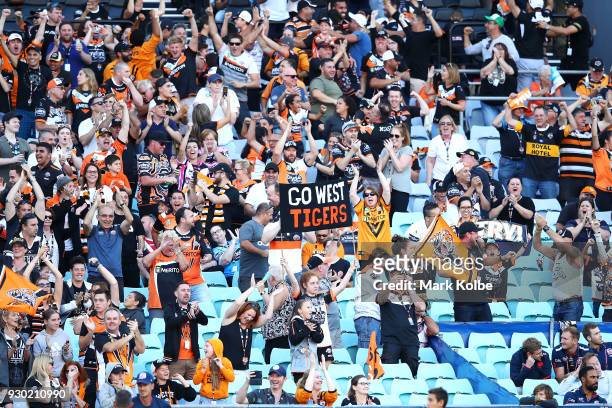 Tigers supporters cheer during the round one NRL match between the Wests Tigers and the Sydney Roosters at ANZ Stadium on March 10, 2018 in Sydney,...