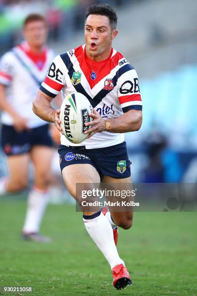 Cooper Cronk of the Roosters runs the ball during the round one NRL match between the Wests Tigers and the Sydney Roosters at ANZ Stadium on March...