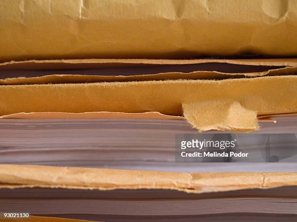 stack of manila envelopes with documents inside - manila envelope stock pictures, royalty-free photos & images