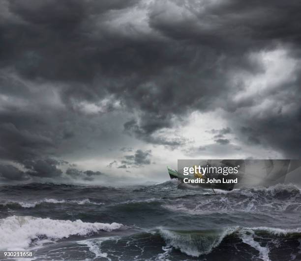 sailor rowing a small boat through an ocean storm - ruffled stock pictures, royalty-free photos & images