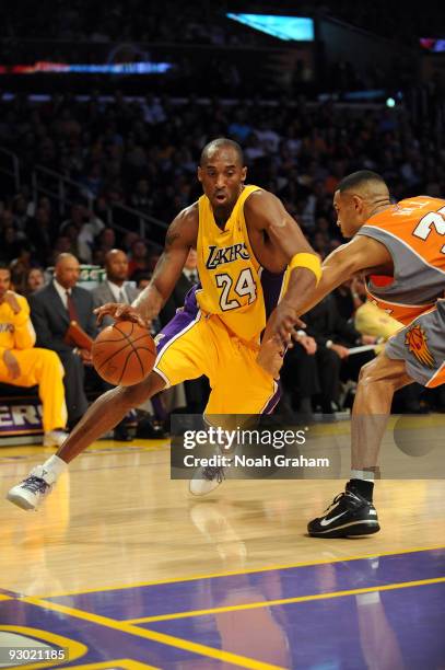 Kobe Bryant of the Los Angeles Lakers drives against Grant Hill of the Phoenix Suns at Staples Center on November 12, 2009 in Los Angeles,...