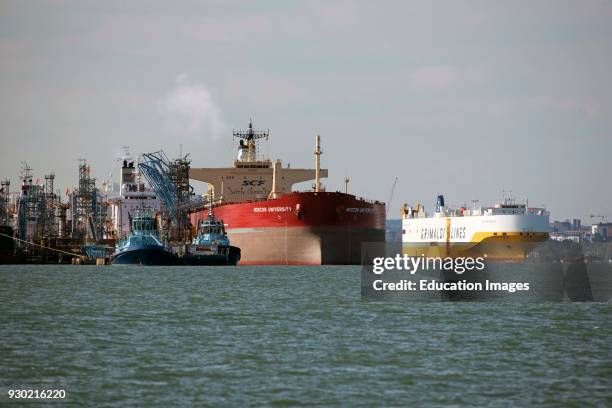 Car carrier Grande Portogallo passing the Russian tanker ship Moscow University alongside the Fawley Marine Terminal on Southampton Water, England UK,