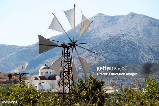 Windmill and church at Agios Georgios on the Lasithi plateau, Crete, Greece.