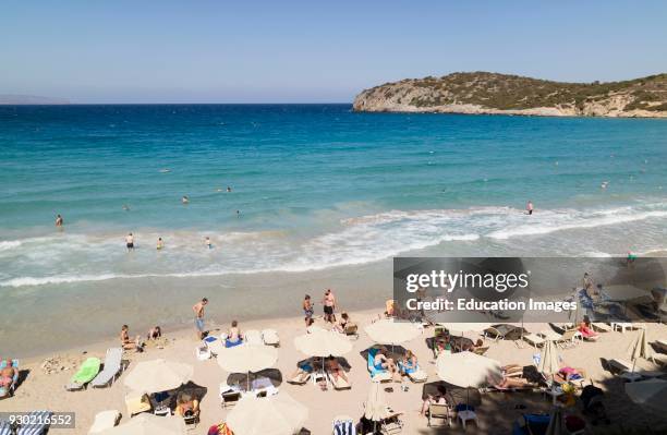 Voulisma Beach south of Agios Nikolaos, Crete, Greece. Holidaymakers on the golden sands.