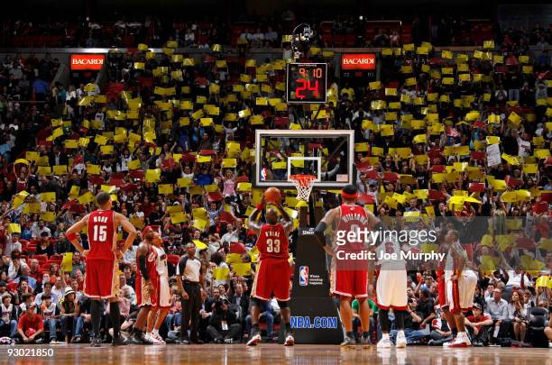Shaquille O'Neal of the Cleveland Cavaliers shoots a freethrow as the Miami Heat fans wave signs on November 12, 2009 at American Airlines Arena in...