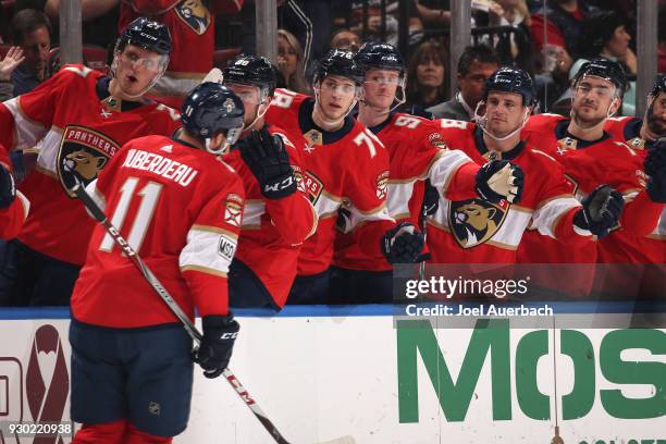 Jonathan Huberdeau of the Florida Panthers is congratulated by teammates after scoring a first period goal against the New York Rangers at the BB&T...