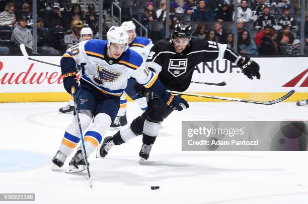 Brayden Schenn of the St. Louis Blues handles the puck against Alex Iafallo of the Los Angeles Kings at STAPLES Center on March 10, 2018 in Los...