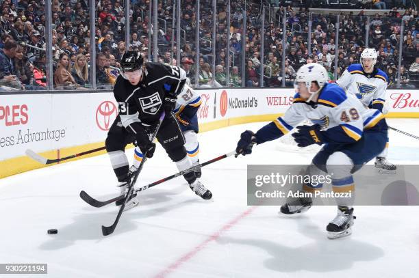 Tyler Toffoli of the Los Angeles Kings handles the puck against Ivan Barbashev of the St. Louis Blues at STAPLES Center on March 10, 2018 in Los...