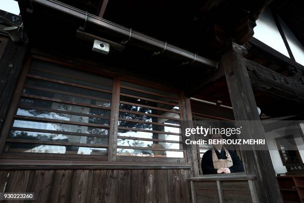 In this picture taken on March 6 Japanese priest Sadamaru Okano, who coordinates with the Safecast non-governmental organisation to measure...