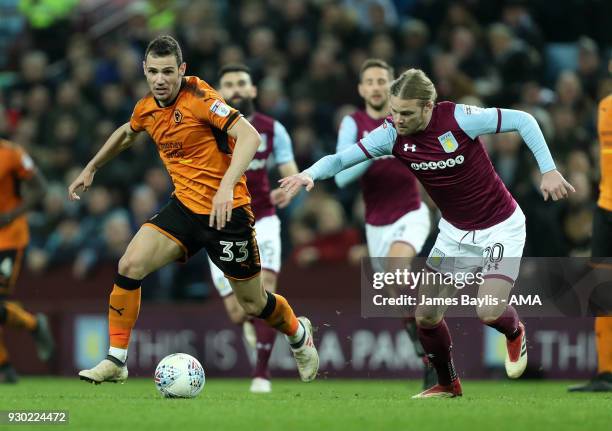 Leo Bonatini of Wolverhampton Wanderers and Birkir Bjarnason of Aston Villa during the Sky Bet Championship match between Aston Villa and...