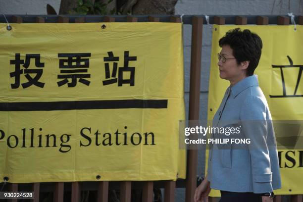 Hong Kong Chief Executive Carrie Lam arrives to cast her vote for the Legislative Council by-elections at a polling station in Hong Kong on March 12,...
