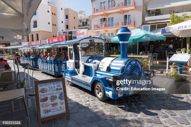 Agios Nikolaos, Crete, Greece. A tourist fun train taking visitors on a tour of the town.