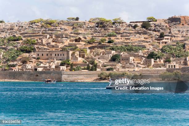 Passenger ferry off Spinalonga Island a former Leper Colony in northern Crete, Greece.