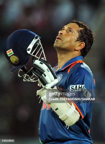 Cricket-IND-Tendulkar, FOCUS In this file photograph taken on November 5 Indian cricketer Sachin Tendulkar celebrates after scoring a century during...