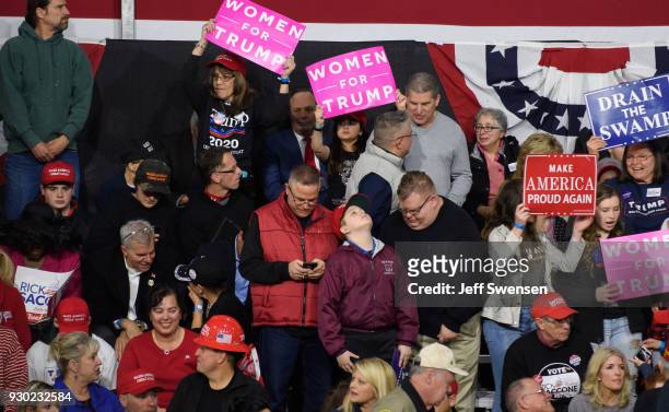 Audience members listen to President Donald J. Trump speak at the Atlantic Aviation Hanger on March 10, 2018 in Moon Township, Pennsylvania. The...