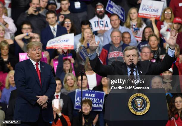 President Donald J. Trump with Rick Saccone speaks to supporters at the Atlantic Aviation Hanger on March 10, 2018 in Moon Township, Pennsylvania....