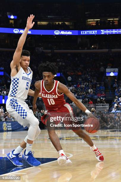 Alabama guard Herbert Jones drives to the basket around Kentucky forward Kevin Knox during a Southeastern Conference Basketball Tournament game...