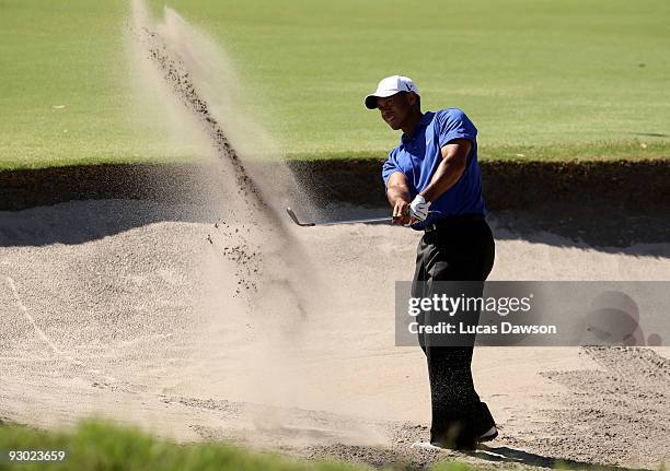 Tiger Woods of the USA plays out of a bunker on the 14th hole during round two of the 2009 Australian Masters at Kingston Heath Golf Club on November...
