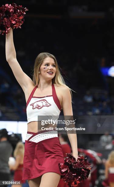 An Arkansas cheerleader performs during a Southeastern Conference Basketball Tournament game between the Tennessee Volunteers and the Arkansas...