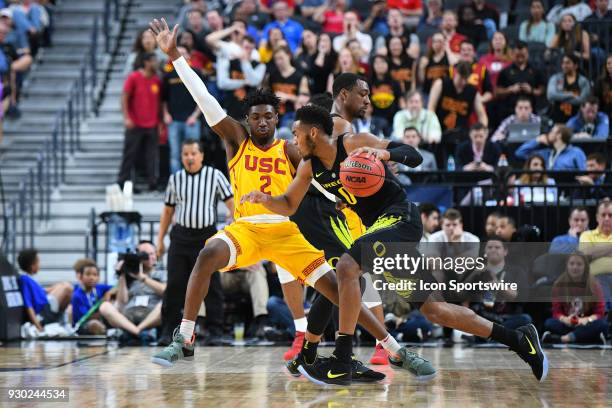 Guard Jonah Mathews defends Oregon forward Troy Brown during the semifinal game of the mens Pac-12 Tournament between the Oregon Ducks and the USC...