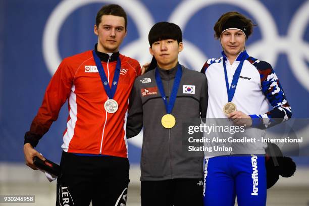 Allan Dahl Johansson of Norway, Jae-Won Chung of Korea and Egor Shkolin of Russia stand on the podium after winning the men's 5000 meter final during...