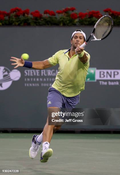 Fernando Verdasco of Spain lunges to return a forehand to Grigor Dimitrov of Russia during the BNP Paribas Open on March 10, 2018 at the Indian Wells...