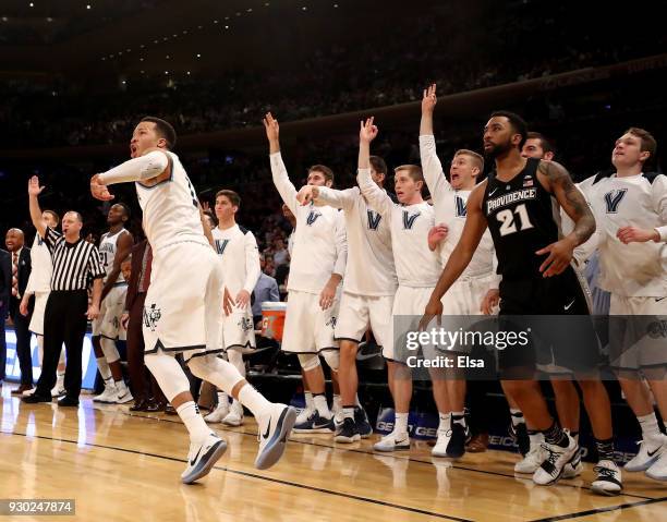 Jalen Brunson of the Villanova Wildcats and the bench celebrate his shot in the second half against the Providence Friars during the championship...