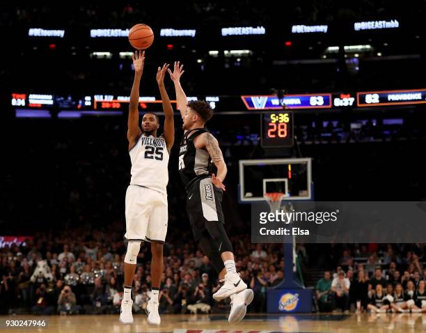 Mikal Bridges of the Villanova Wildcats takes a shot as Drew Edwards of the Providence Friars defends during the championship game of the Big East...