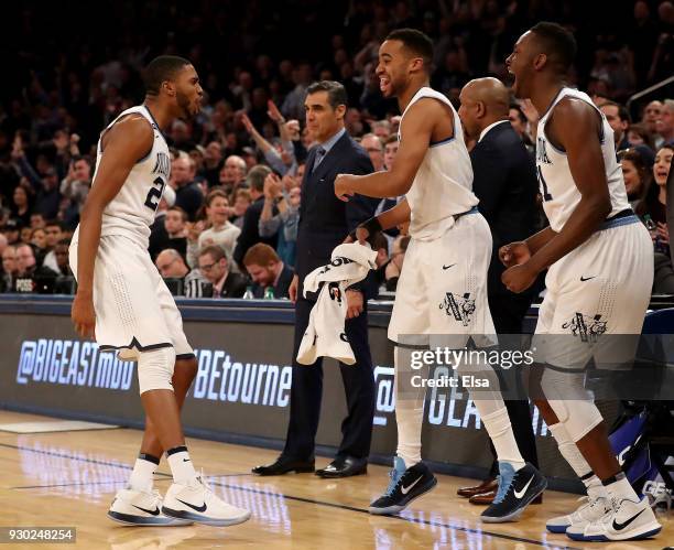 Mikal Bridges of the Villanova Wildcats celebrates his three point shot with the bench during overtime period against the Providence Friars in the...