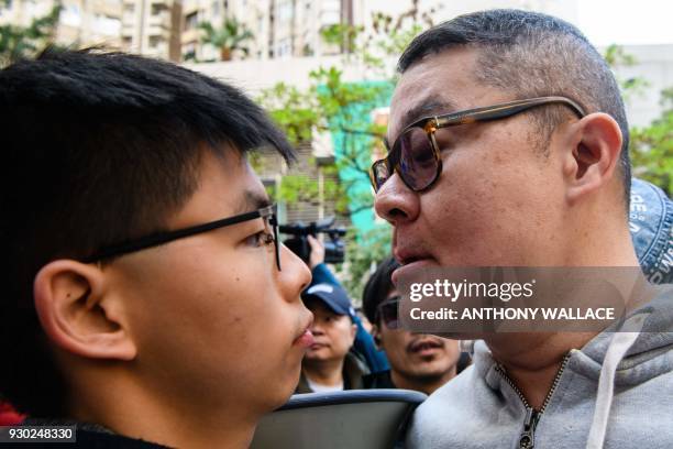 Man faces off with pro-democracy campaigner Joshua Wong as he and other campaigners gather to support by-election candidate Au Nok-hin for the...