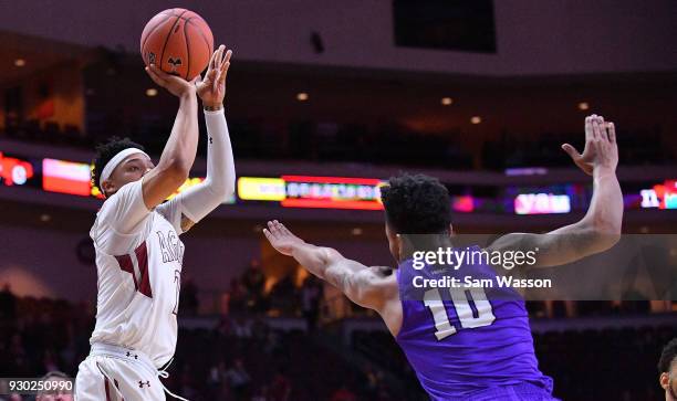 Zach Lofton of the New Mexico State Aggies shoots against Damari Milstead of the Grand Canyon Lopes during the championship game of the Western...