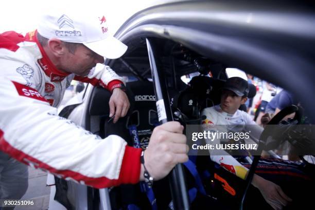 French driver Sebastien Loeb chats with his compatriot Sebastian Ogier during the second day of the 2018 FIA World Rally Championship in Leon,...