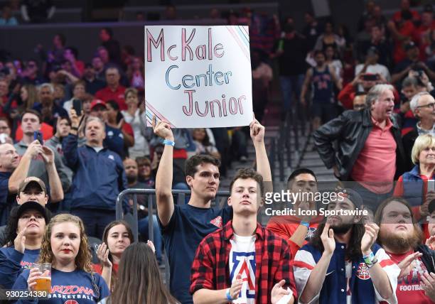 An Arizona fan holds up a sign reading, "McKale Center Junior" in recognition of the large volume of Arizona fans in attendance during the PAC-12...