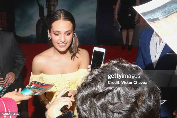 Actress Alicia Vikander signs autographs and takes selfies with fans during the "Tomb Raider" Mexico City premiere at Oasis Coyoacan on March 10,...